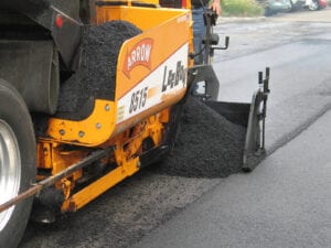 closeup shot of asphalt being paved