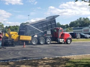 truck dumping out asphalt